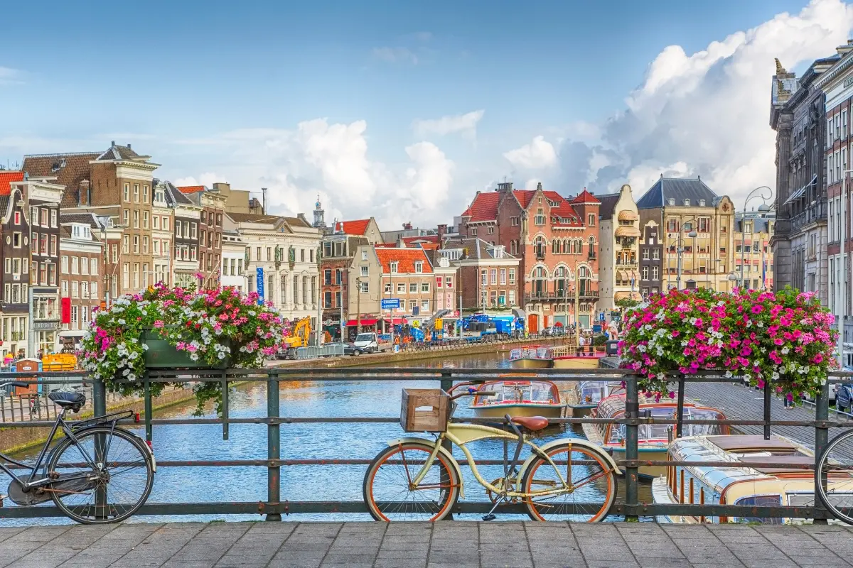 Bicicletas y canal de Ámsterdam con casas históricas